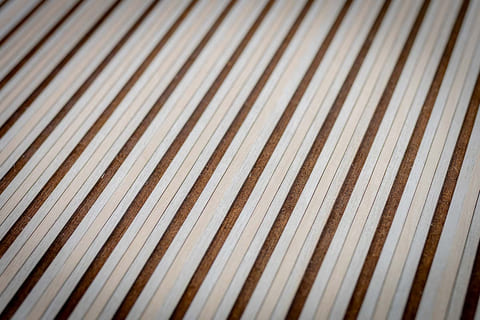 Micro-perforated wooden panel with a design pattern