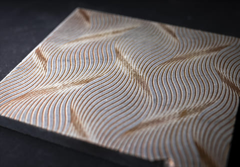 Finished marble panel with a laser-engraved pattern